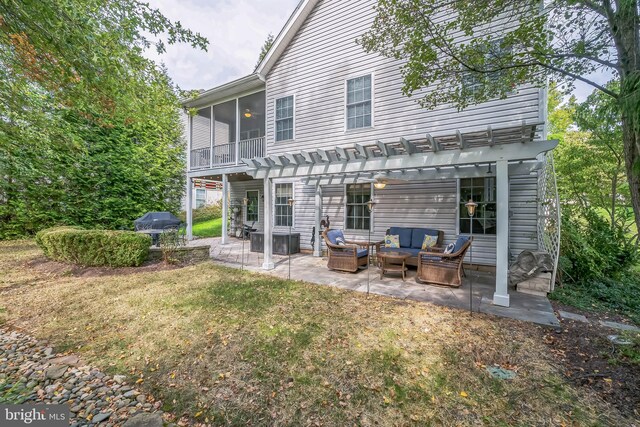 back of house featuring a lawn, a pergola, outdoor lounge area, and a patio area