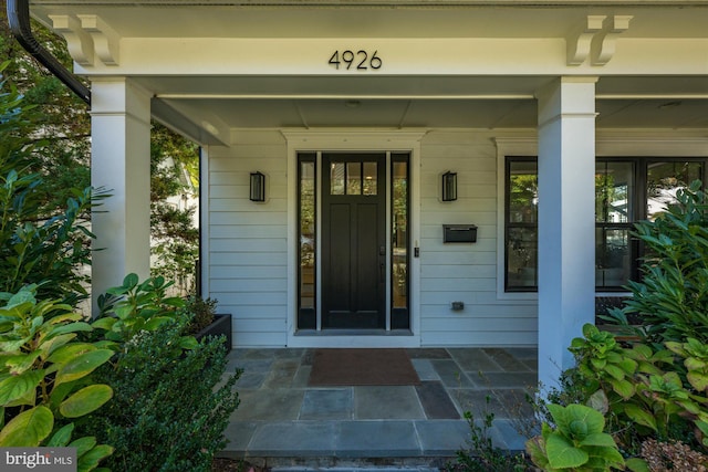 property entrance with covered porch