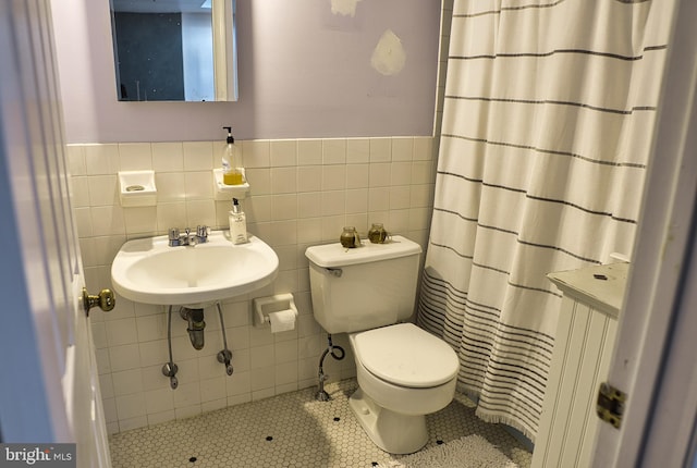 bathroom featuring tile walls, sink, tile patterned floors, and toilet