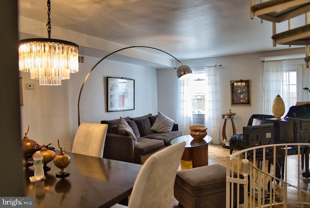 living room with a notable chandelier and plenty of natural light