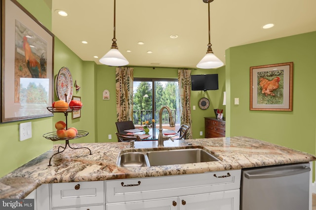 kitchen featuring white cabinets, dishwasher, pendant lighting, and sink