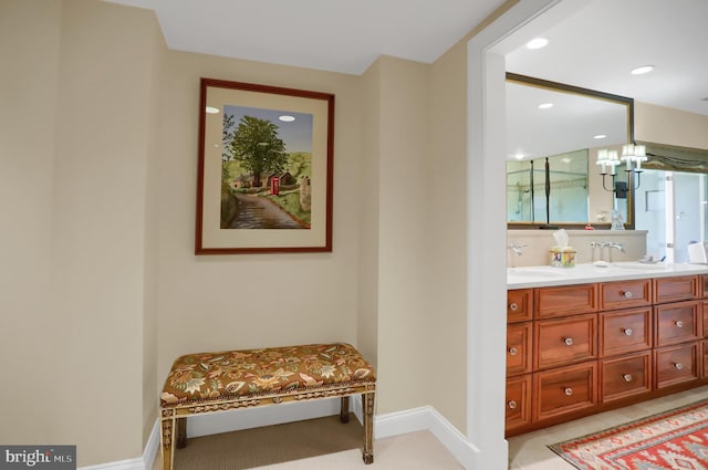 bathroom featuring a notable chandelier and vanity