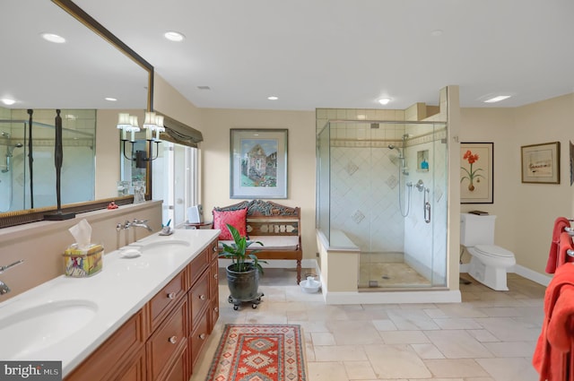 bathroom featuring vanity, a shower with shower door, toilet, and a chandelier