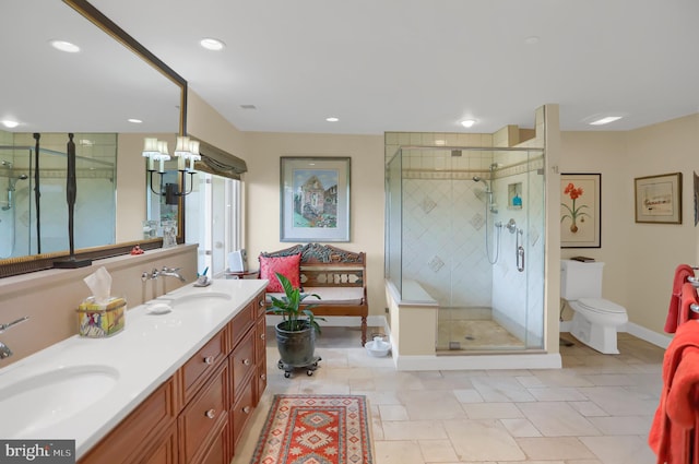 full bath with a stall shower, double vanity, a sink, and an inviting chandelier