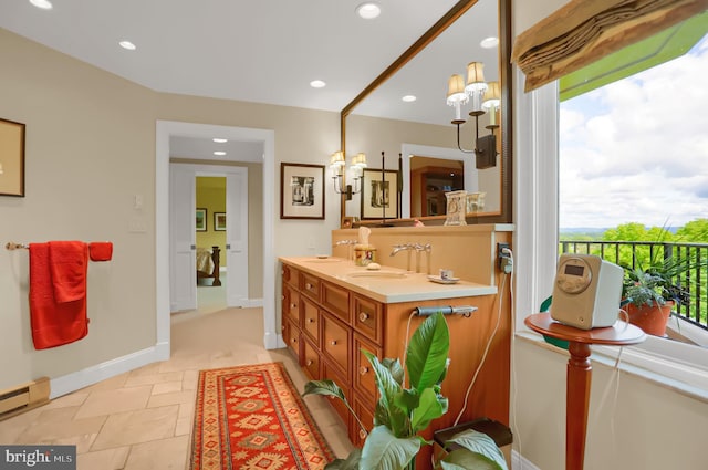 bathroom with vanity, an inviting chandelier, and a baseboard radiator