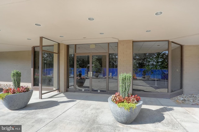 entrance to property featuring brick siding