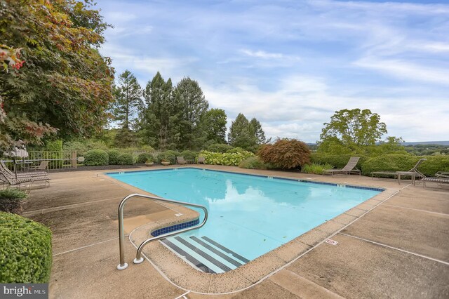 community pool featuring a patio area