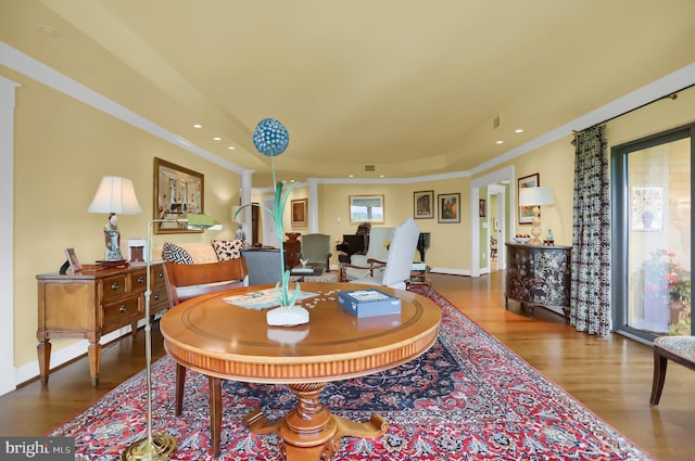 dining area with recessed lighting, wood finished floors, and ornamental molding