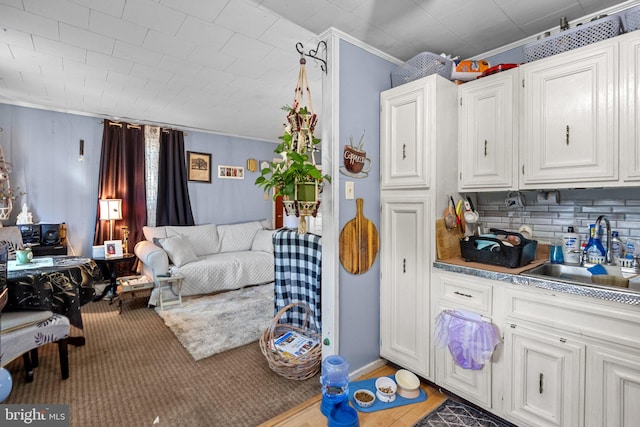 interior space with hardwood / wood-style floors, crown molding, and sink