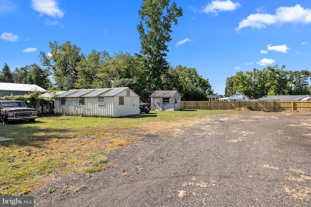 exterior space featuring a shed and a yard