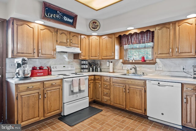 kitchen with sink, white appliances, and tasteful backsplash