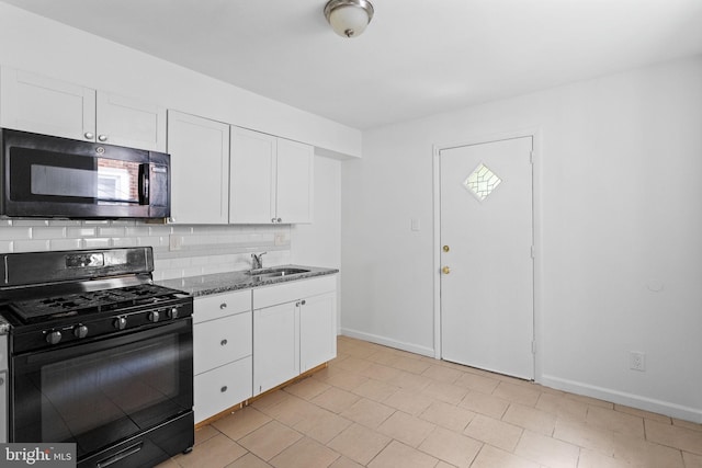 kitchen with sink, white cabinets, decorative backsplash, black gas range, and dark stone countertops