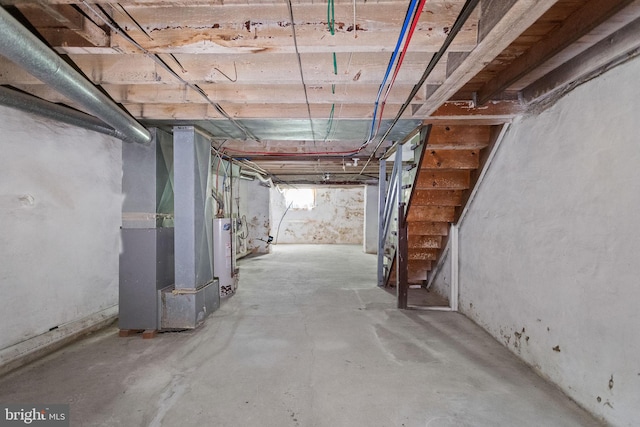 basement featuring water heater and heating unit