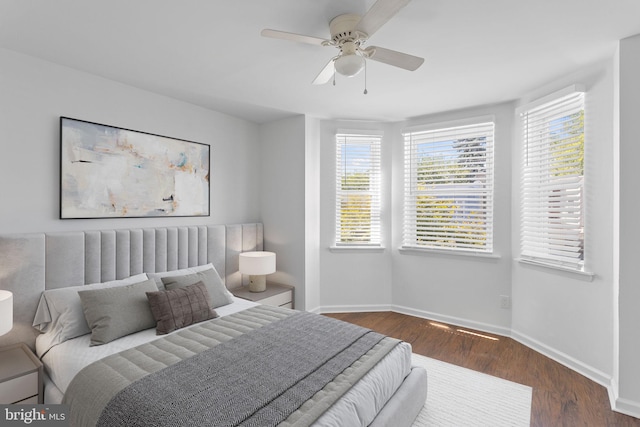 bedroom with ceiling fan and dark hardwood / wood-style floors