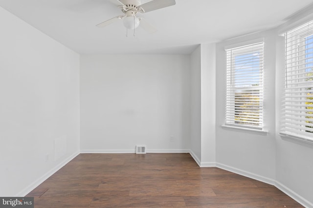 unfurnished room featuring ceiling fan and dark hardwood / wood-style floors