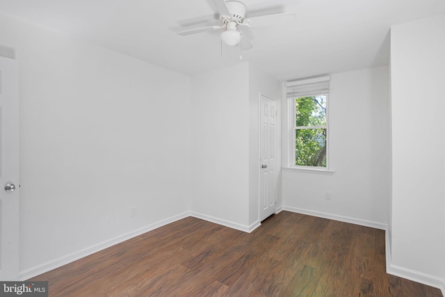 empty room featuring ceiling fan and dark hardwood / wood-style flooring