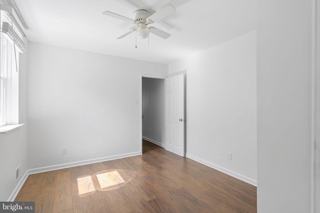 empty room featuring ceiling fan and dark wood-type flooring