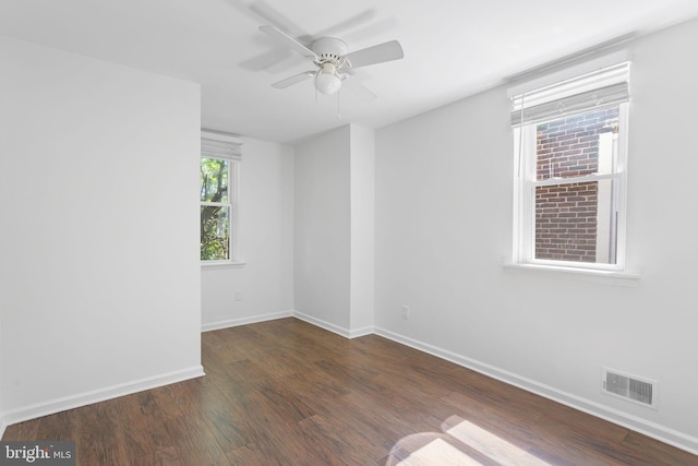 unfurnished room with ceiling fan and dark wood-type flooring