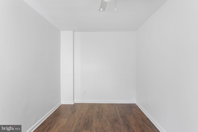 spare room featuring ceiling fan and dark wood-type flooring