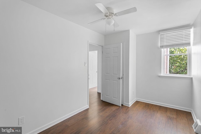 unfurnished bedroom featuring dark hardwood / wood-style flooring and ceiling fan