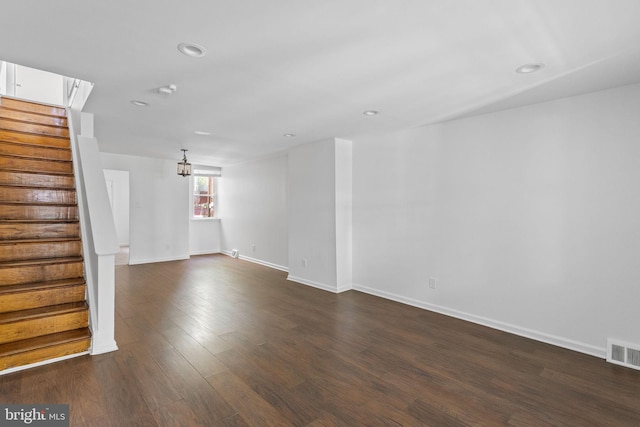 spare room featuring dark wood-type flooring