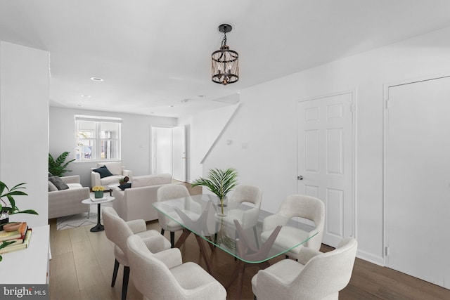 dining area featuring a notable chandelier and dark hardwood / wood-style flooring