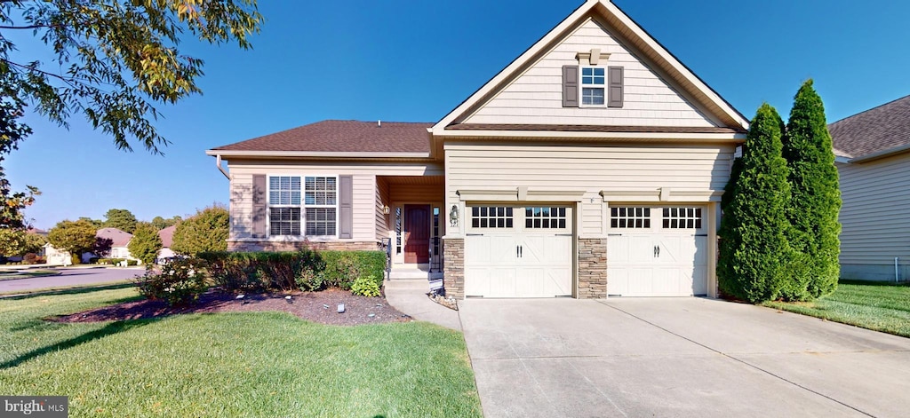 view of front of home with a front yard and a garage