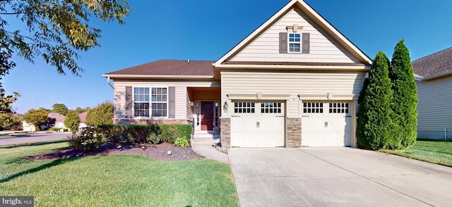 view of front of home with a front yard and a garage