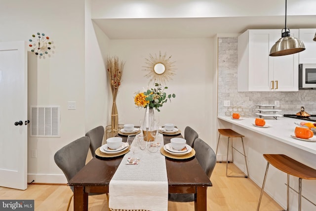 dining space with light wood-type flooring