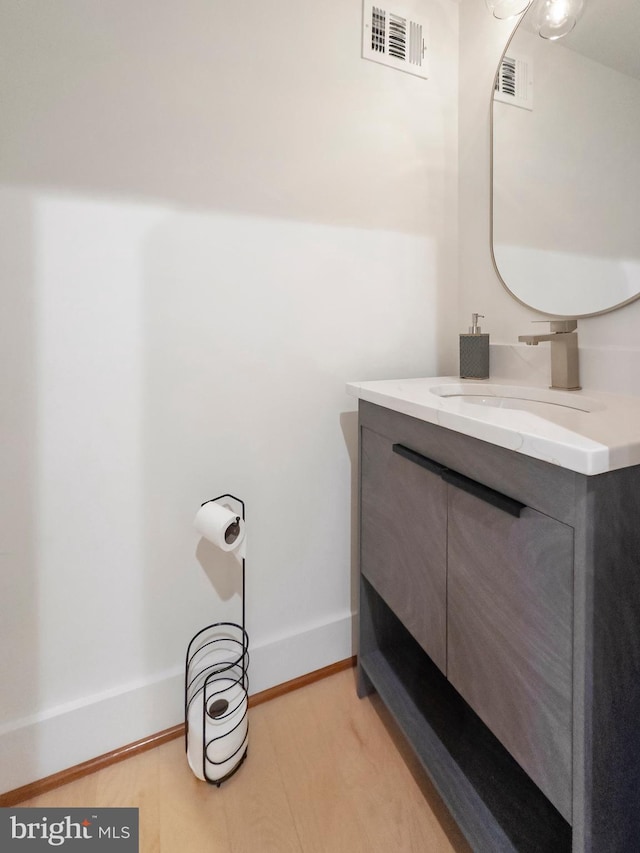 bathroom with vanity and hardwood / wood-style floors