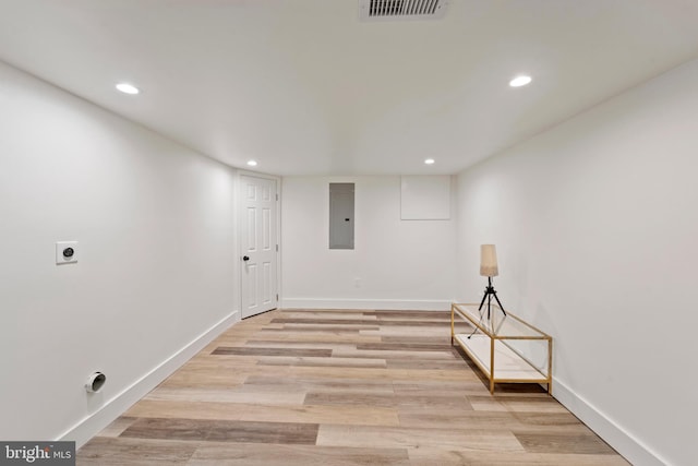 spare room with light hardwood / wood-style floors and electric panel