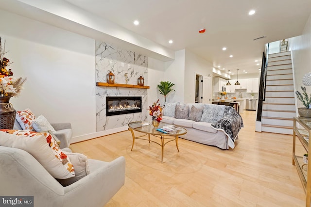 living room featuring light hardwood / wood-style floors and a fireplace