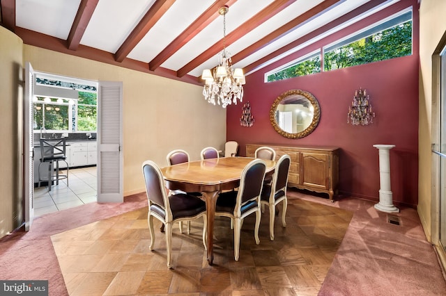 tiled dining room featuring lofted ceiling with beams and a chandelier