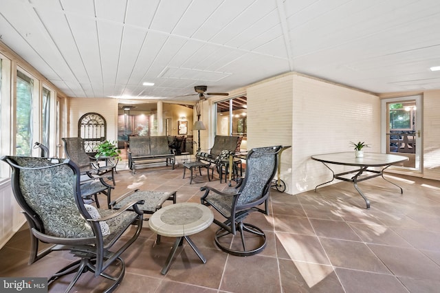 sunroom / solarium with ceiling fan and a wealth of natural light