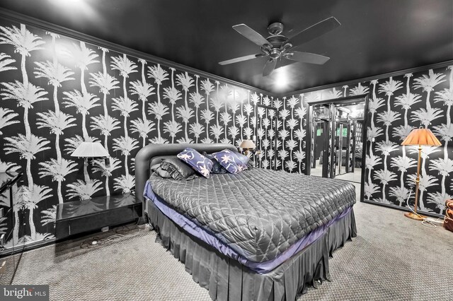 carpeted bedroom with ornamental molding and ceiling fan