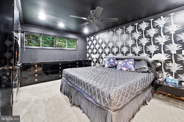 carpeted bedroom featuring ceiling fan and ornamental molding