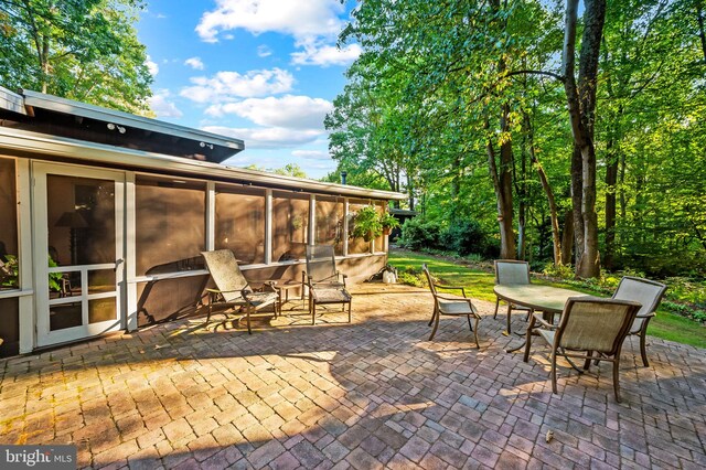 view of patio / terrace featuring a sunroom