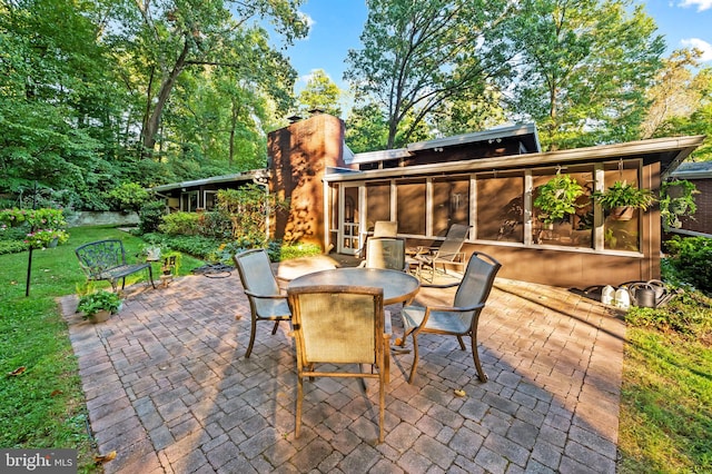 view of patio / terrace featuring a sunroom