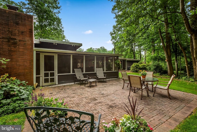 view of patio / terrace featuring a sunroom