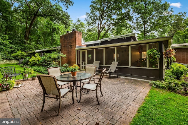 view of patio with a sunroom