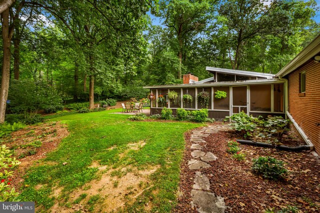 view of yard with a sunroom