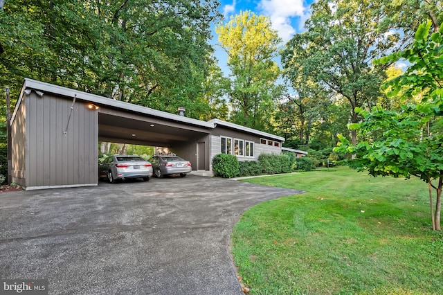 exterior space with a lawn and a carport