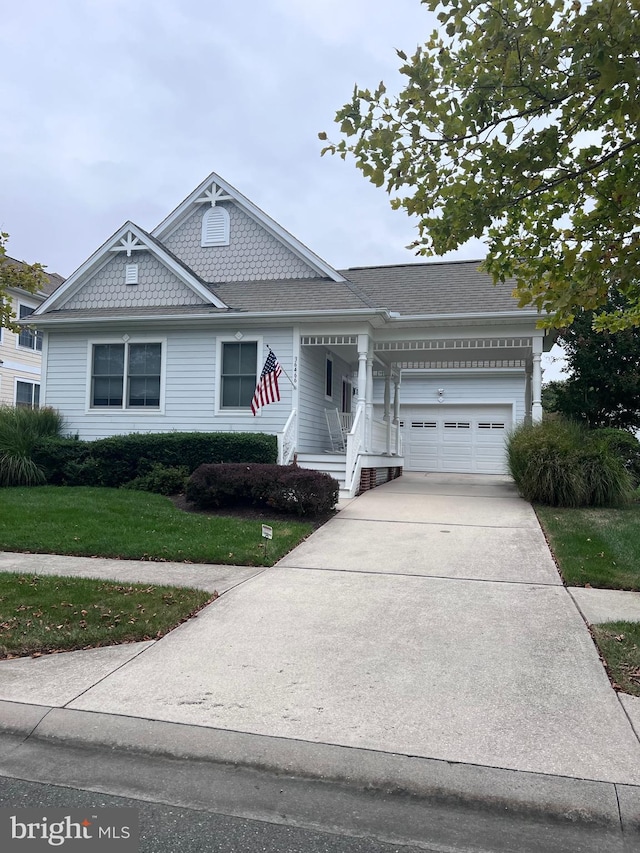 view of front of house with a front yard and a garage