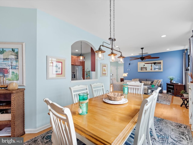 dining space featuring ceiling fan and light hardwood / wood-style flooring