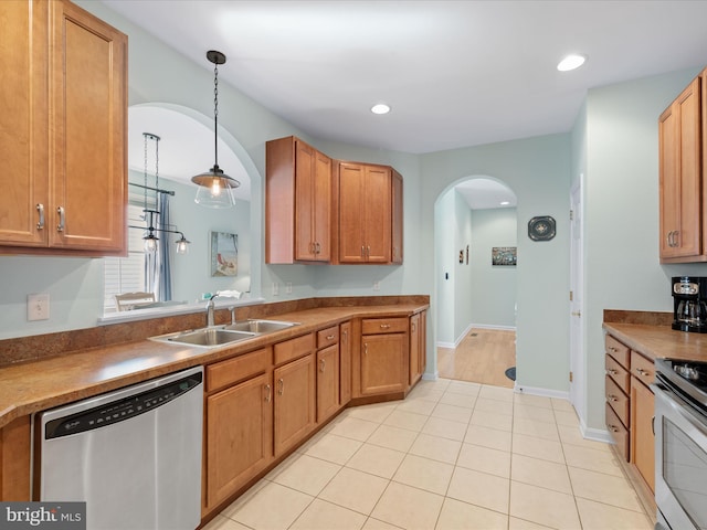 kitchen with stainless steel appliances, hanging light fixtures, light tile patterned flooring, and sink