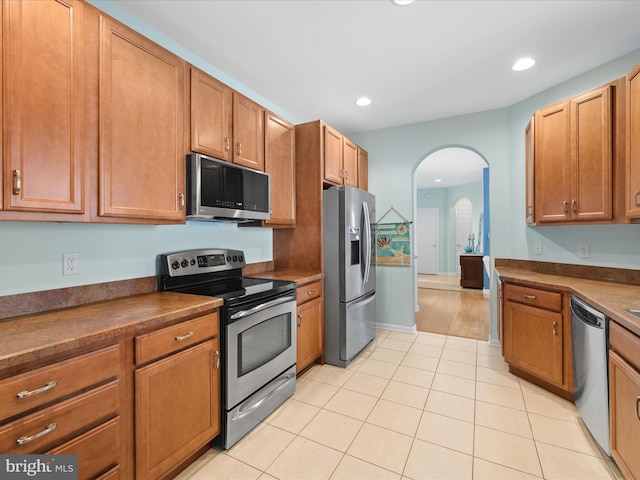 kitchen featuring stainless steel appliances and light tile patterned floors