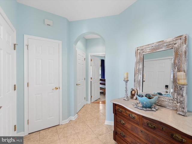 hall featuring light tile patterned floors