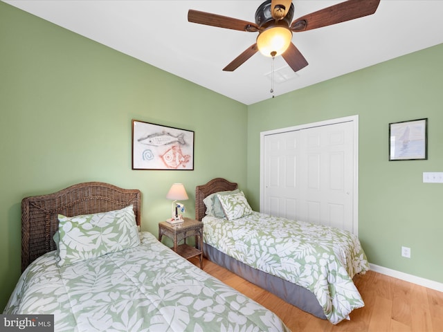 bedroom with ceiling fan, a closet, and light wood-type flooring