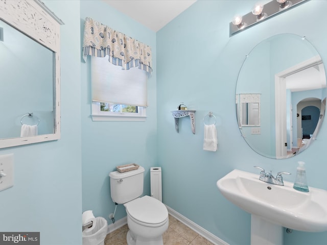 bathroom with sink, toilet, and tile patterned floors