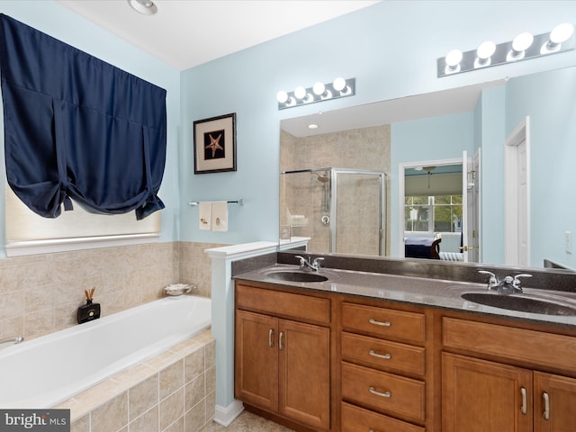 bathroom featuring independent shower and bath and vanity